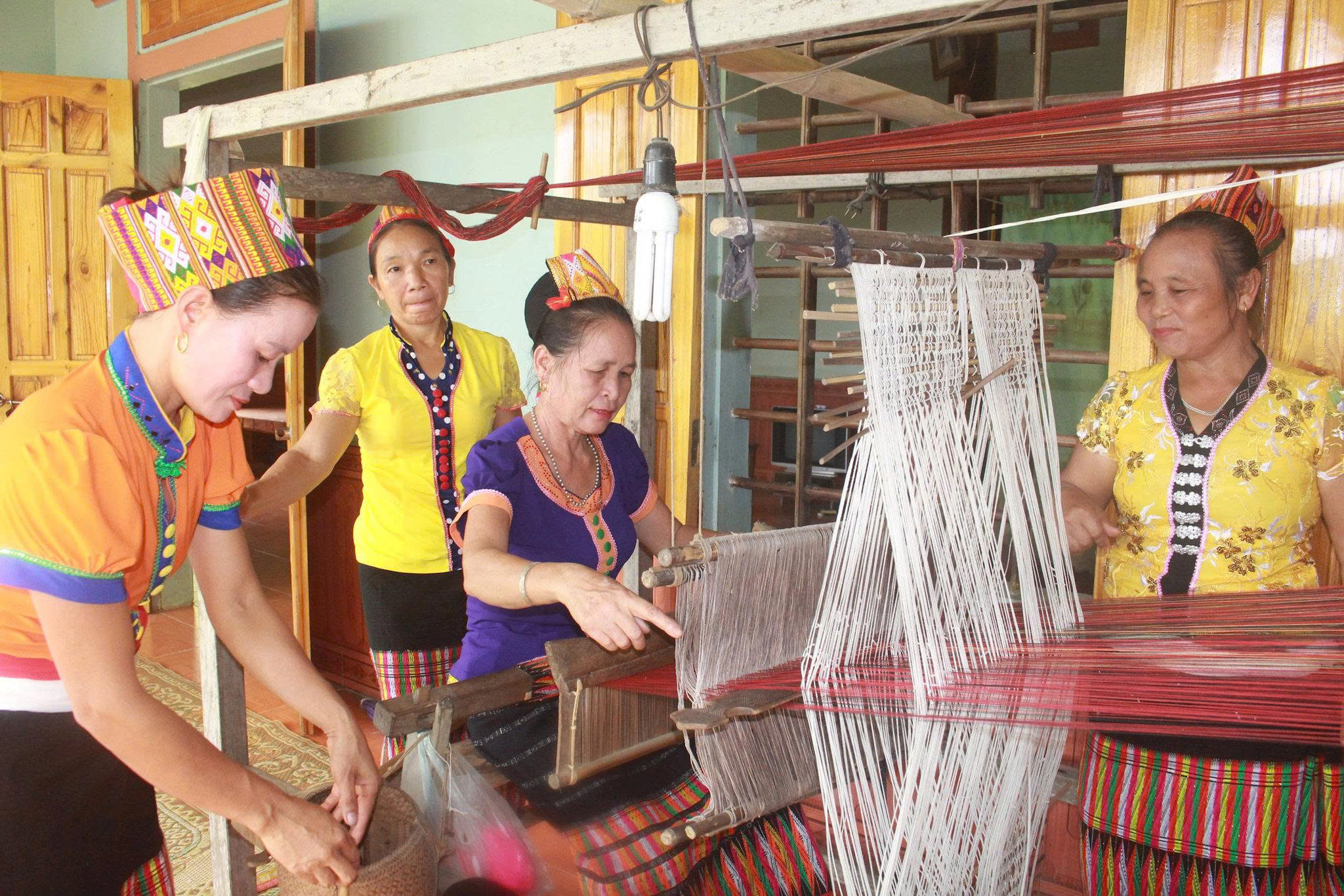 Thai woman weaving traditional brocade in But Village Thai woman weaving traditional brocade in But Village
